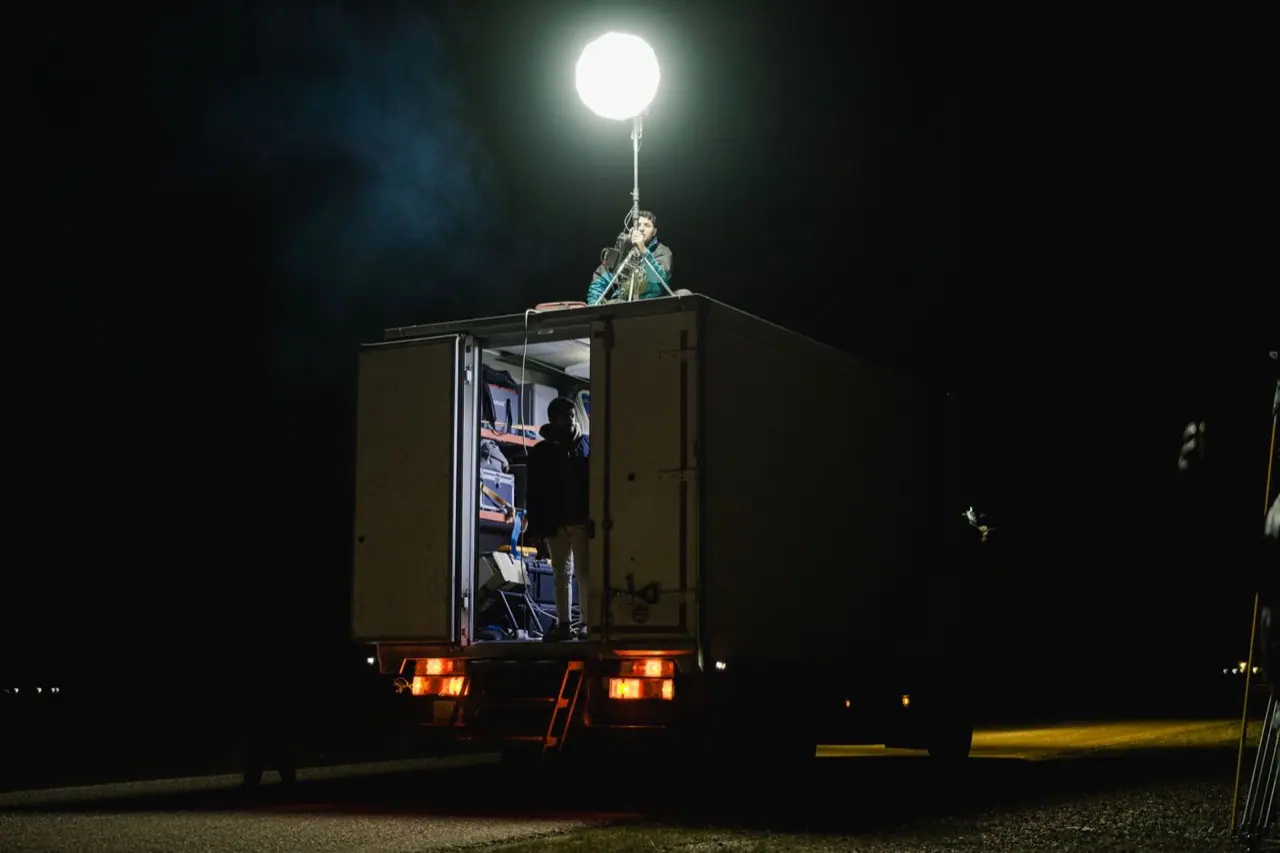 Night film set lit by a truck-mounted balloon light