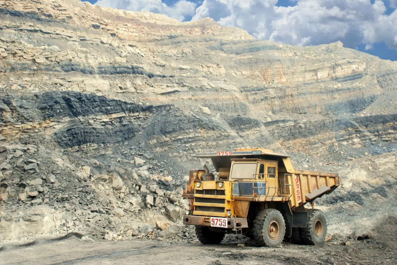 Heavy truck working in an open-pit quarry at a remote site